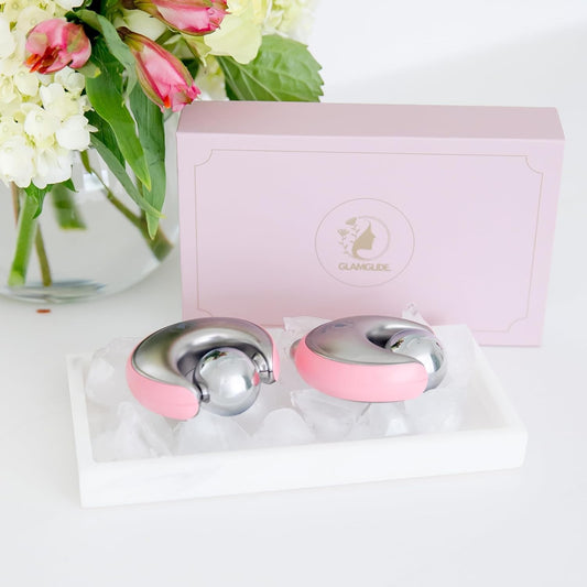 Havefy GLAMGLIDE pink and silver cryo facial massagers resting on ice in a white tray with a matching gift box.