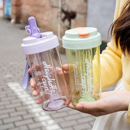 Havefy pastel fruit infuser water bottles with straw and carry strap held in hands